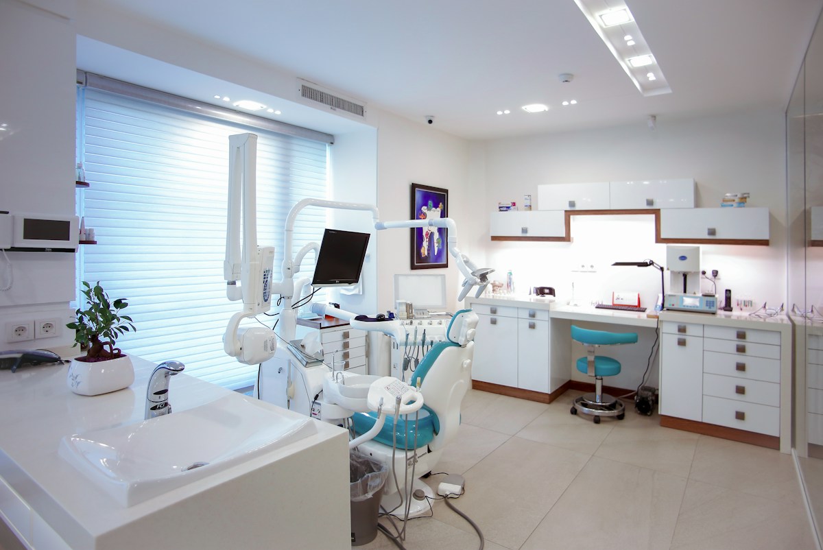 Illustrative dental practice interior behind a first-visit content idea
